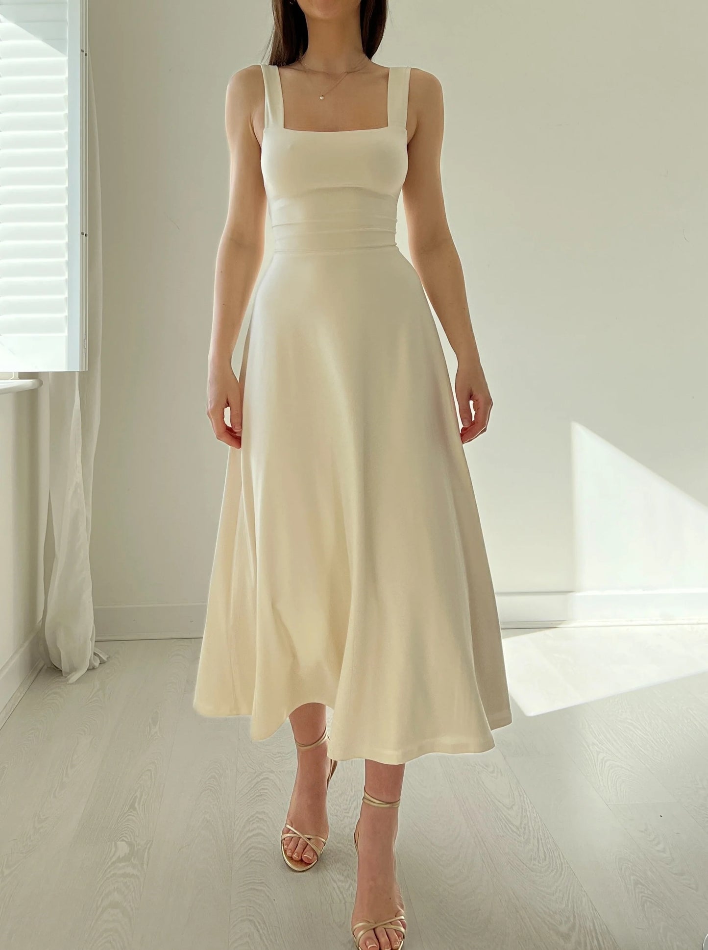 Corset style with a more elastic waist, mid-length skirt