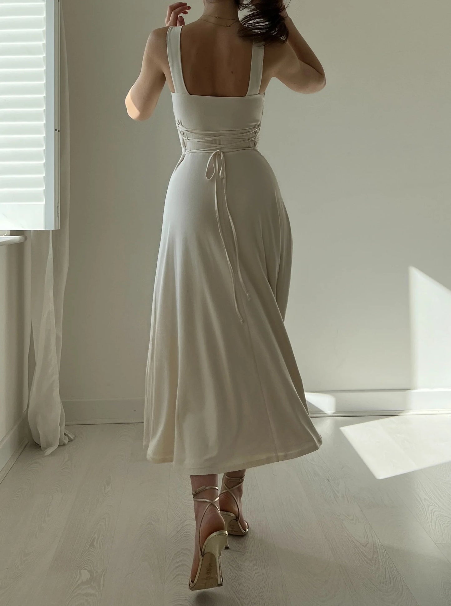 Corset style with a more elastic waist, mid-length skirt