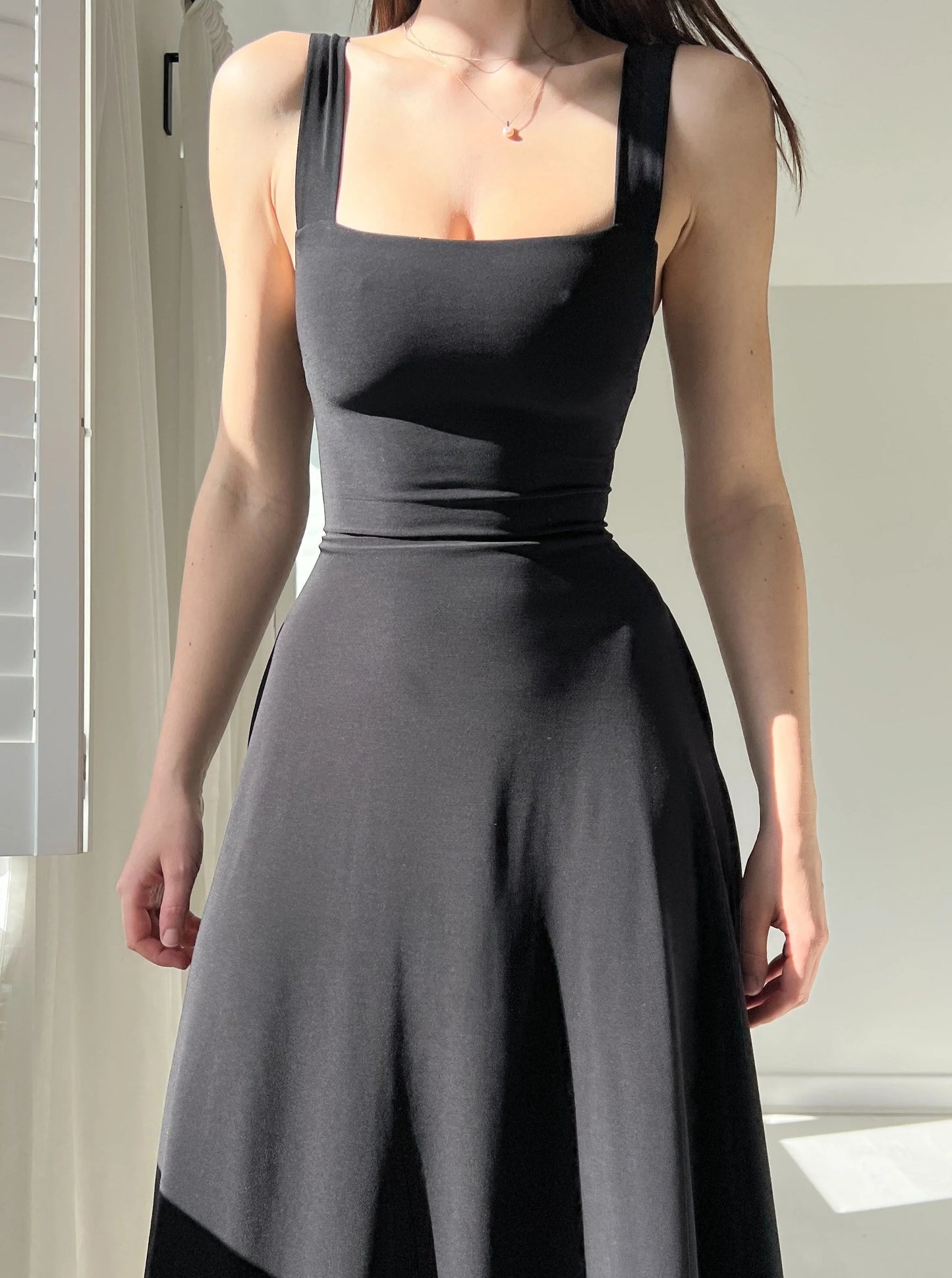 Corset style with a more elastic waist, mid-length skirt